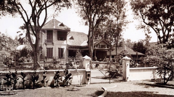 a large house with a fence and trees