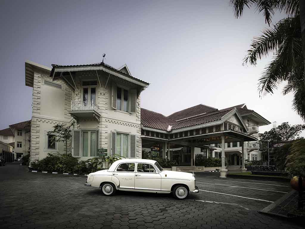 a white car parked in front of a building