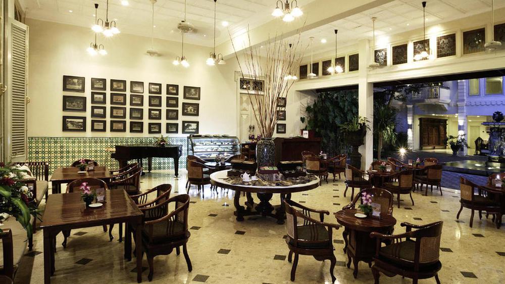 a room with a piano and tables