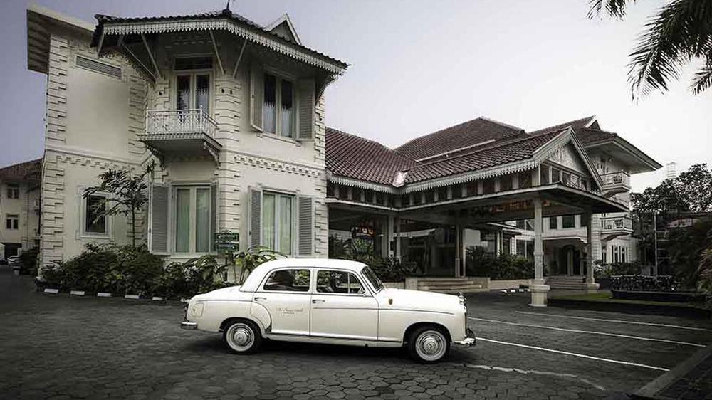 a white car parked in front of a building