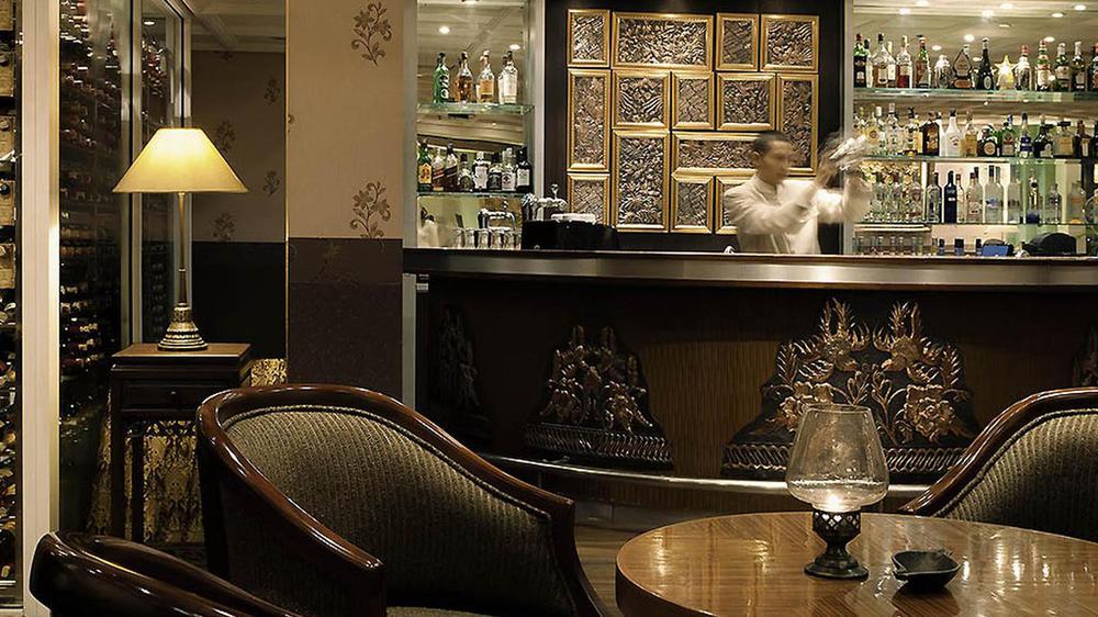 a man standing behind a bar counter