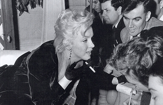 a woman signing autographs