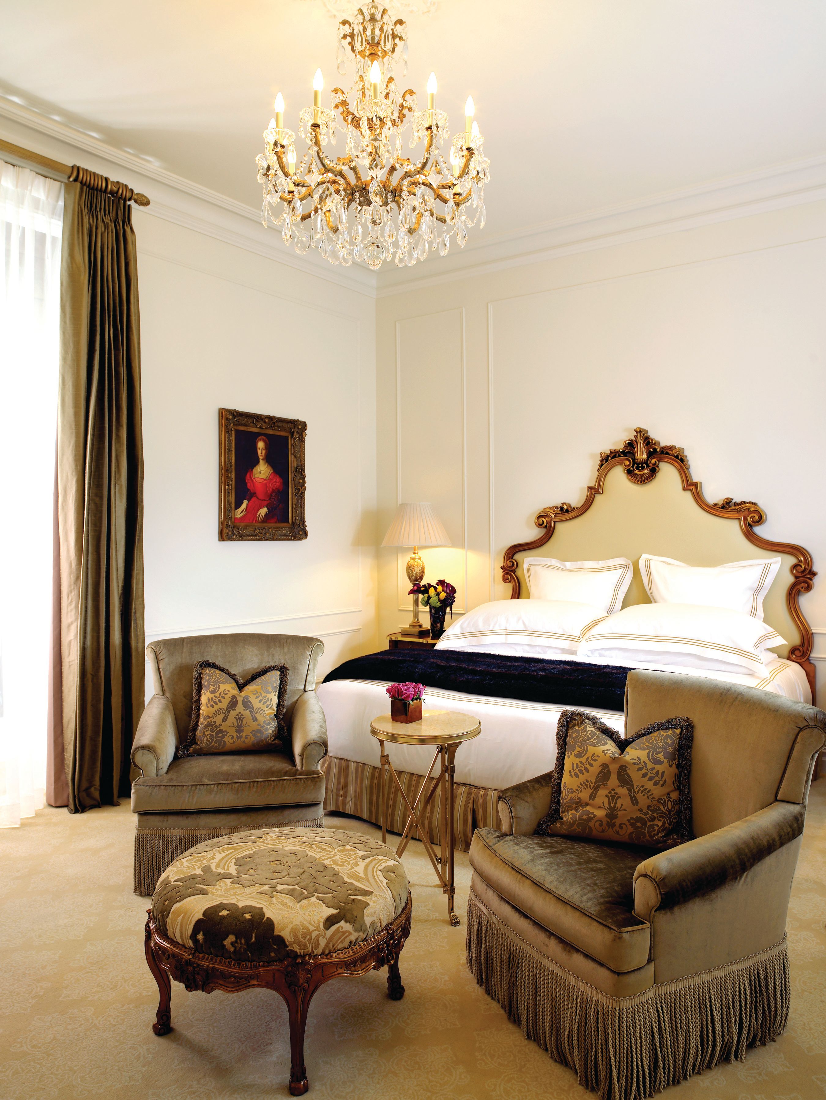 a bedroom with a bed and chairs