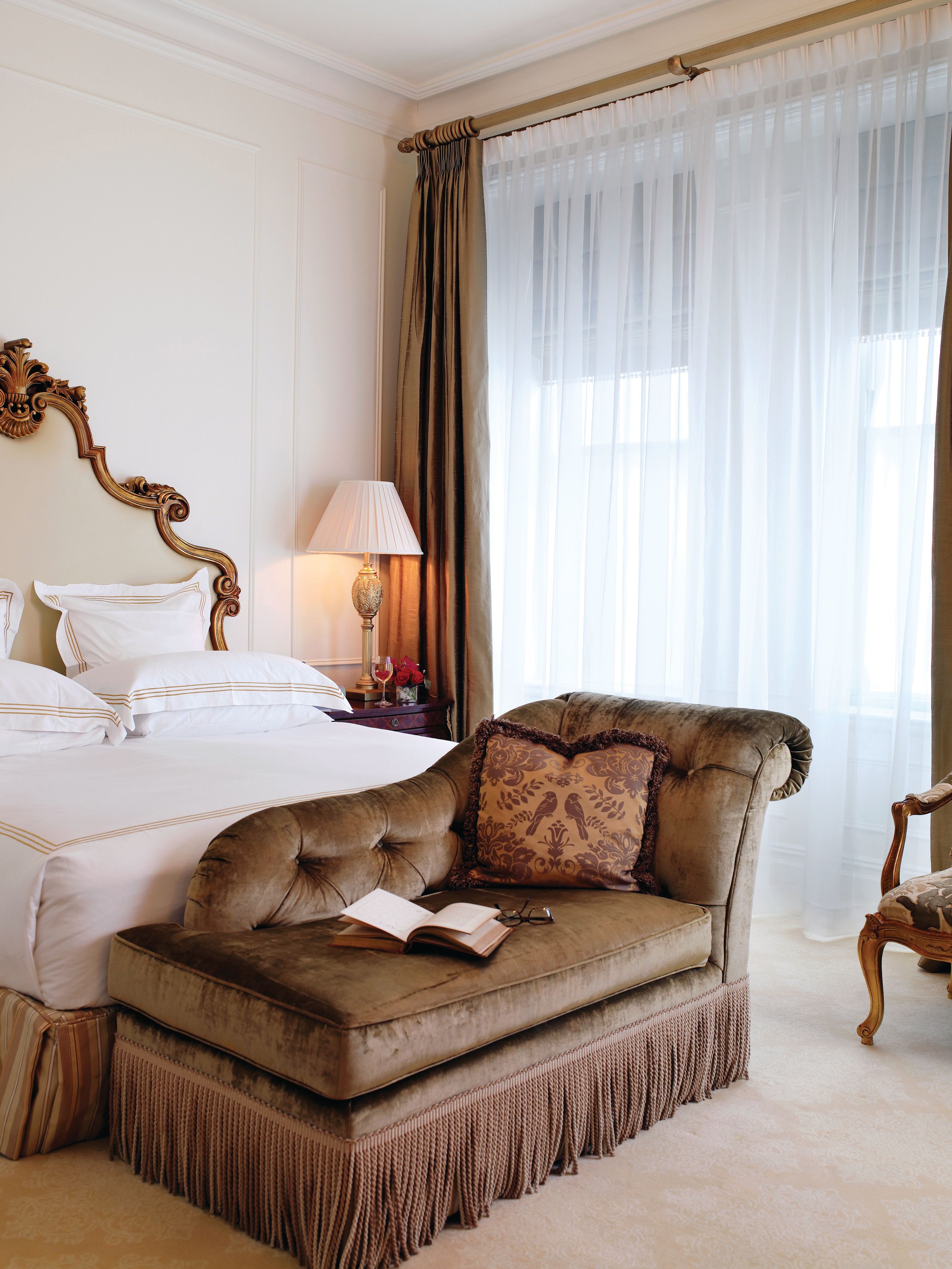 a bedroom with a chair and a book
