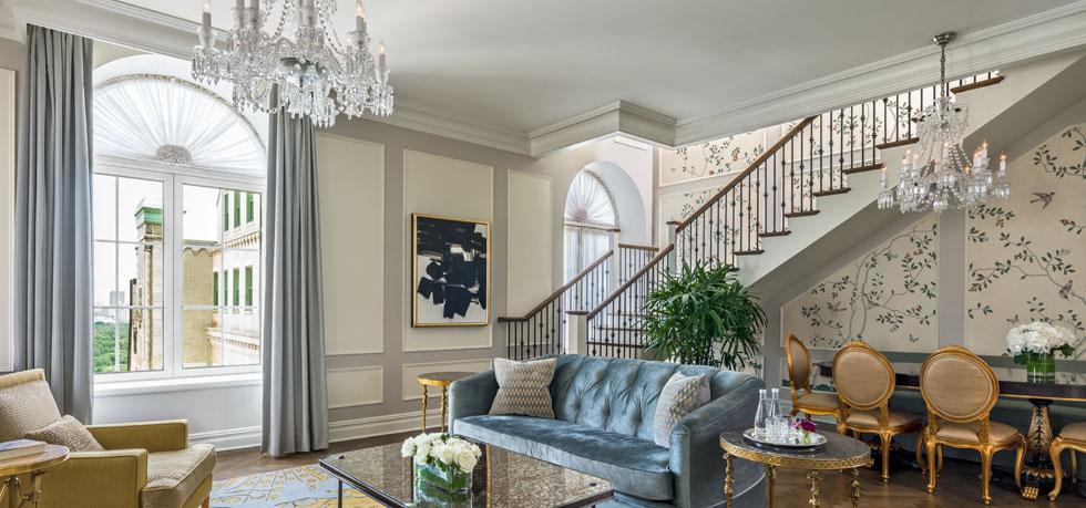 a living room with a staircase and a couch