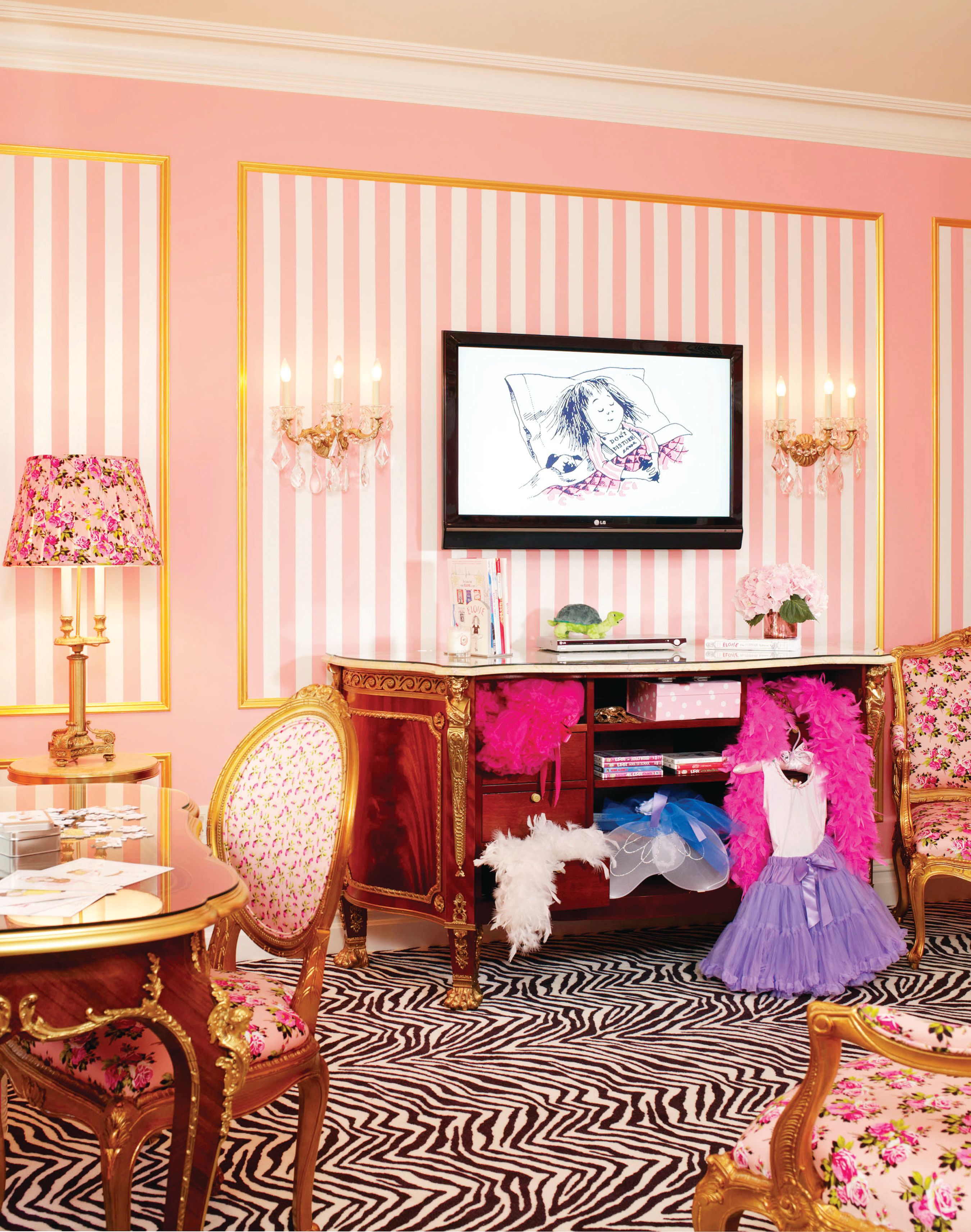 a room with pink striped walls and a table and chairs