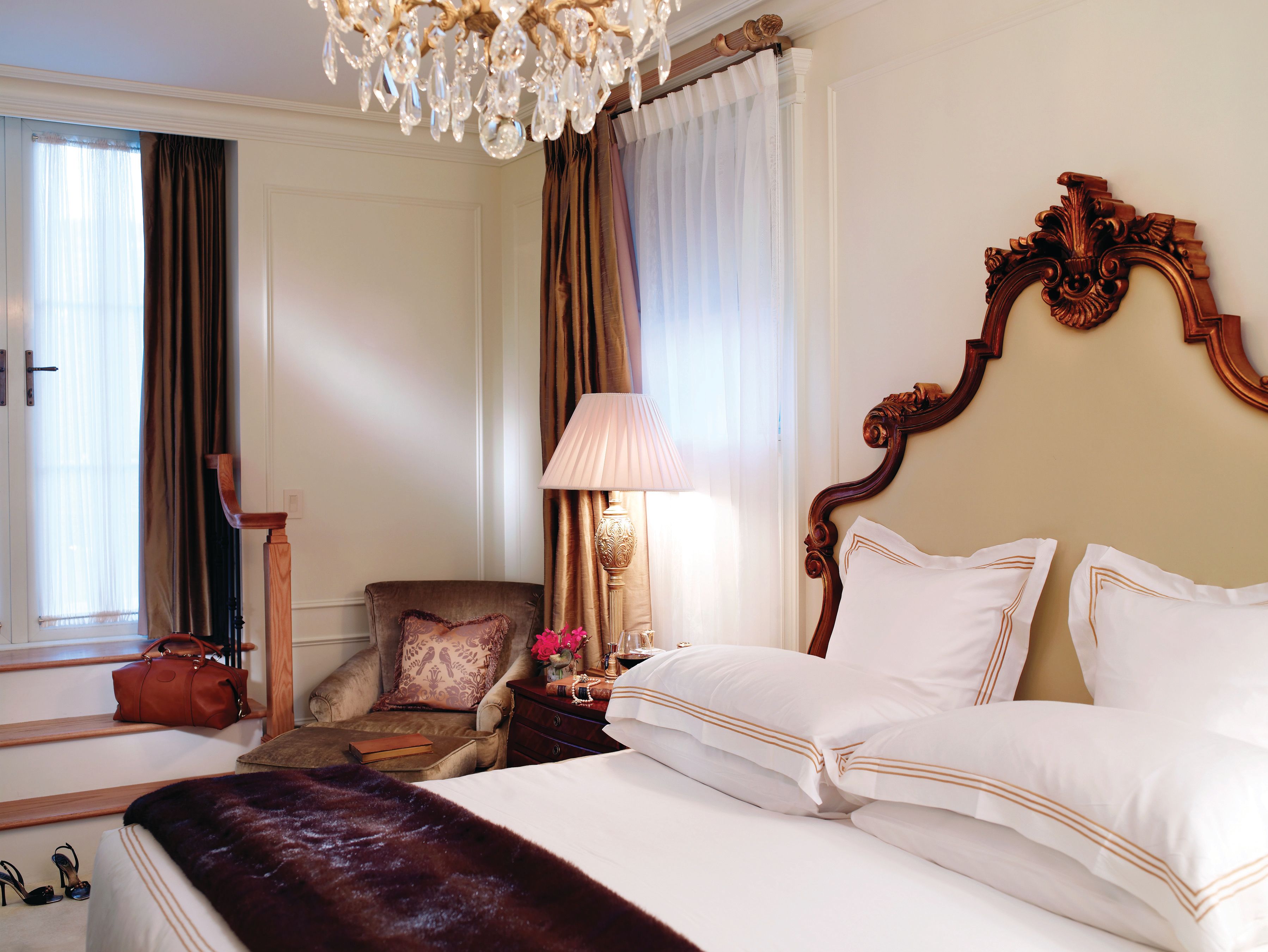 a bedroom with a chandelier and a bed