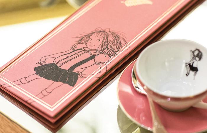 a pink menu with a drawing on it