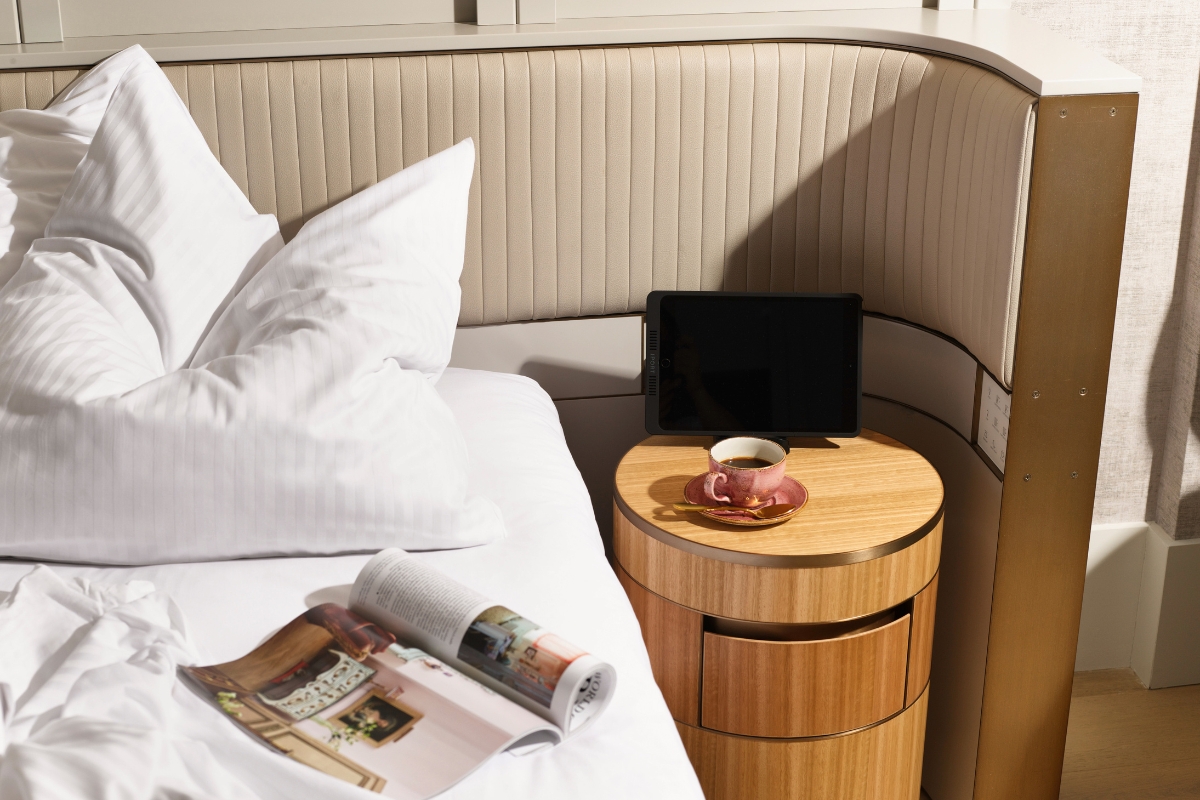 a table with a cup of coffee and a magazine on it