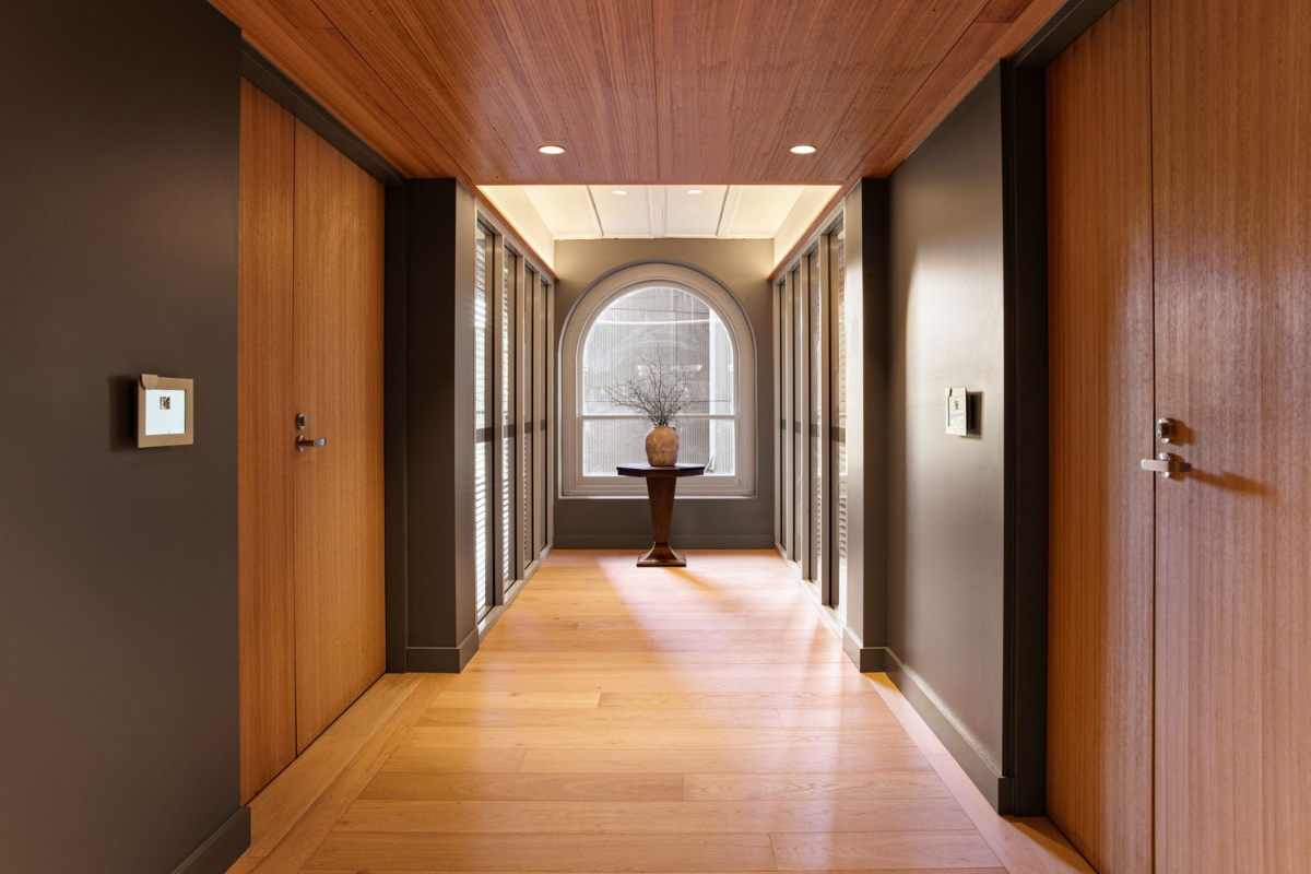 a hallway with a vase on a table