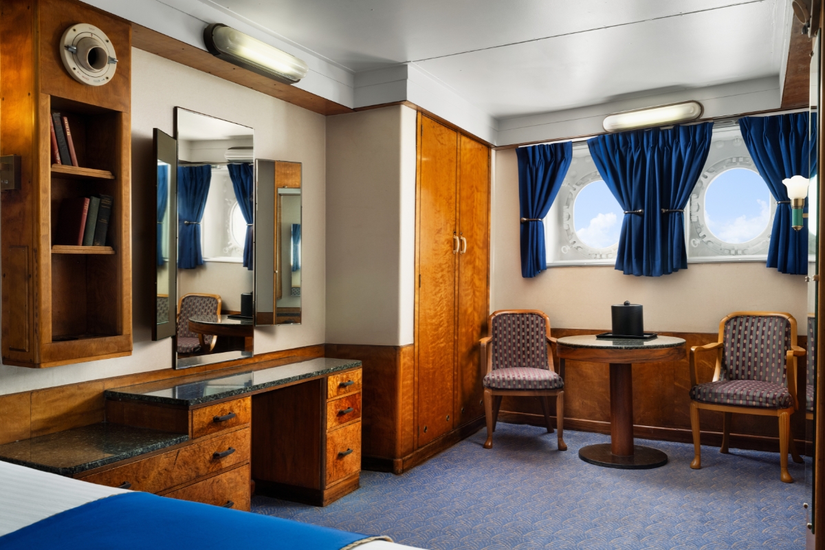a room with a table and chair and a mirror