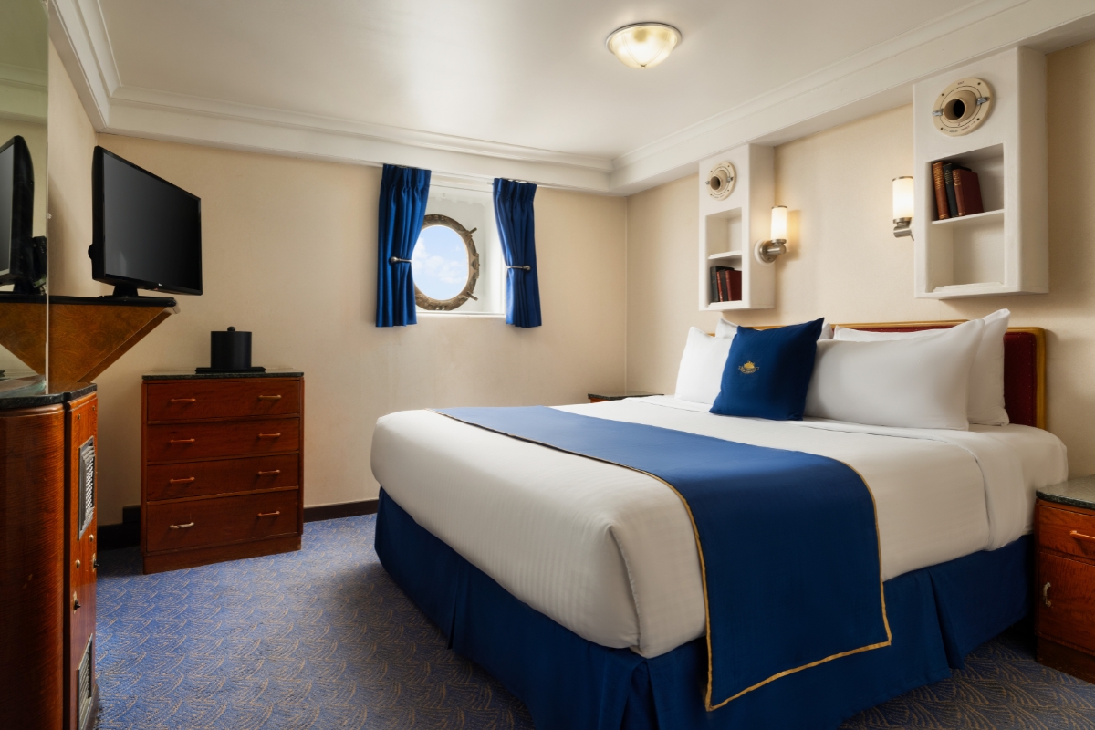 a room with a bed and a television