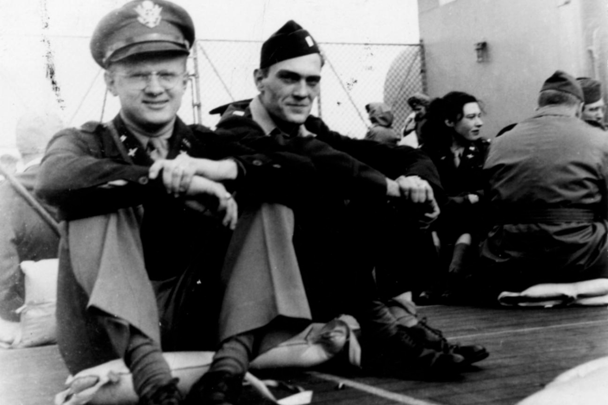 a group of men sitting on a deck