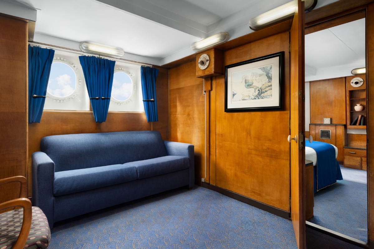 a room with a couch and windows