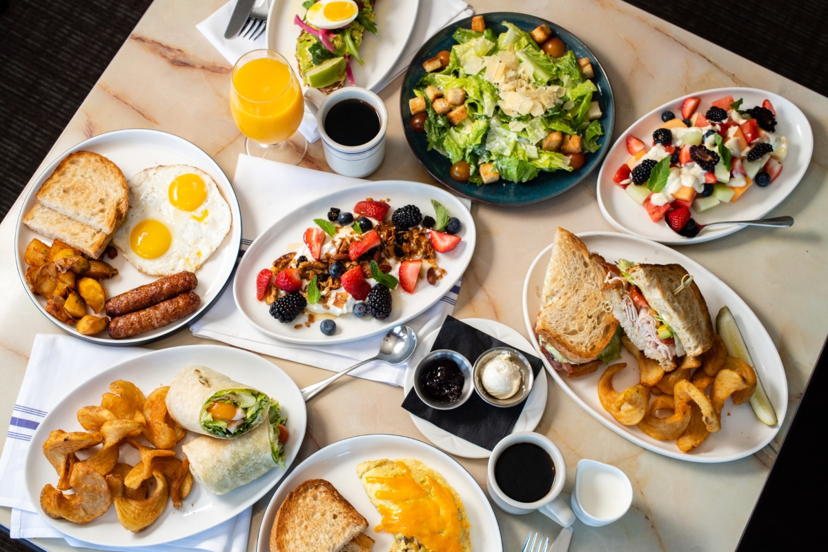 a table with plates of food and drinks