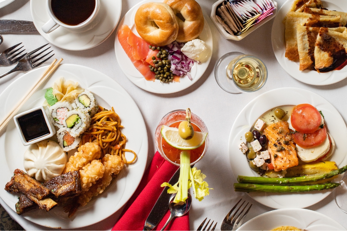 a table with plates of food and drinks