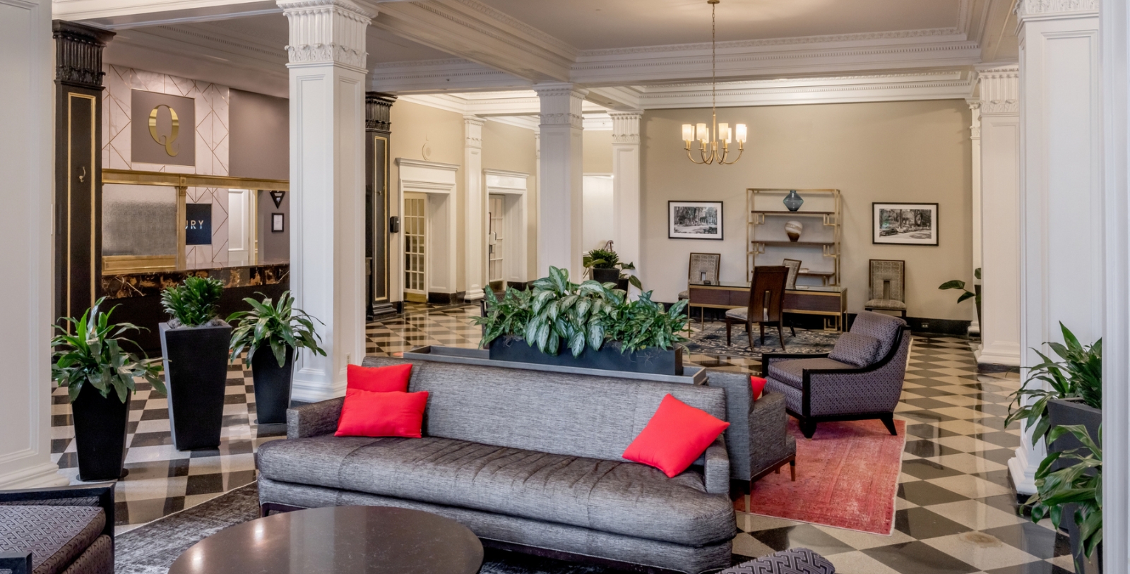 a room with a couch and chairs