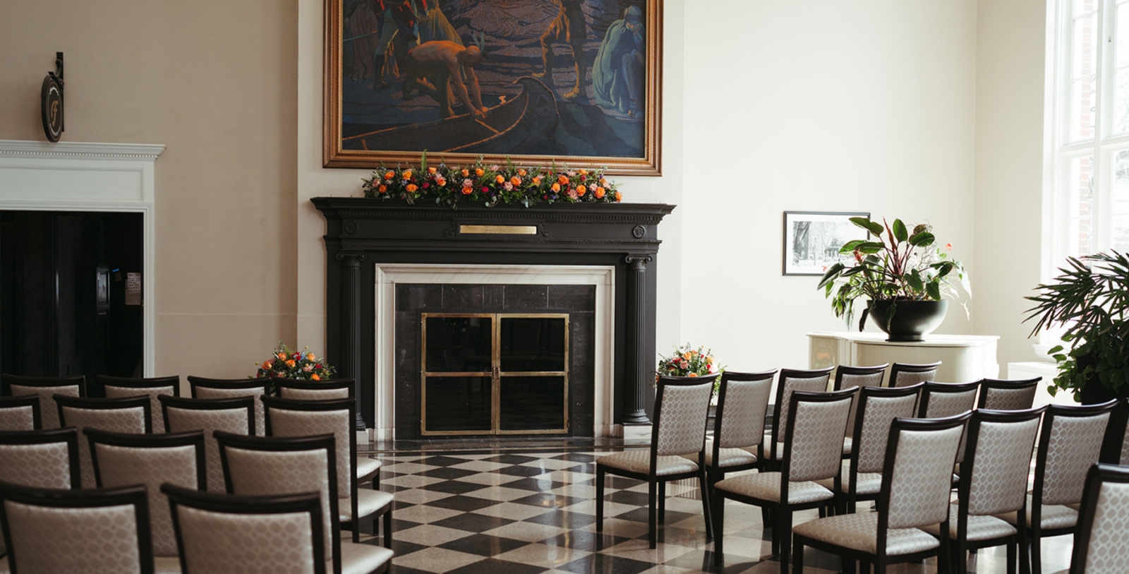 a room with chairs and a fireplace