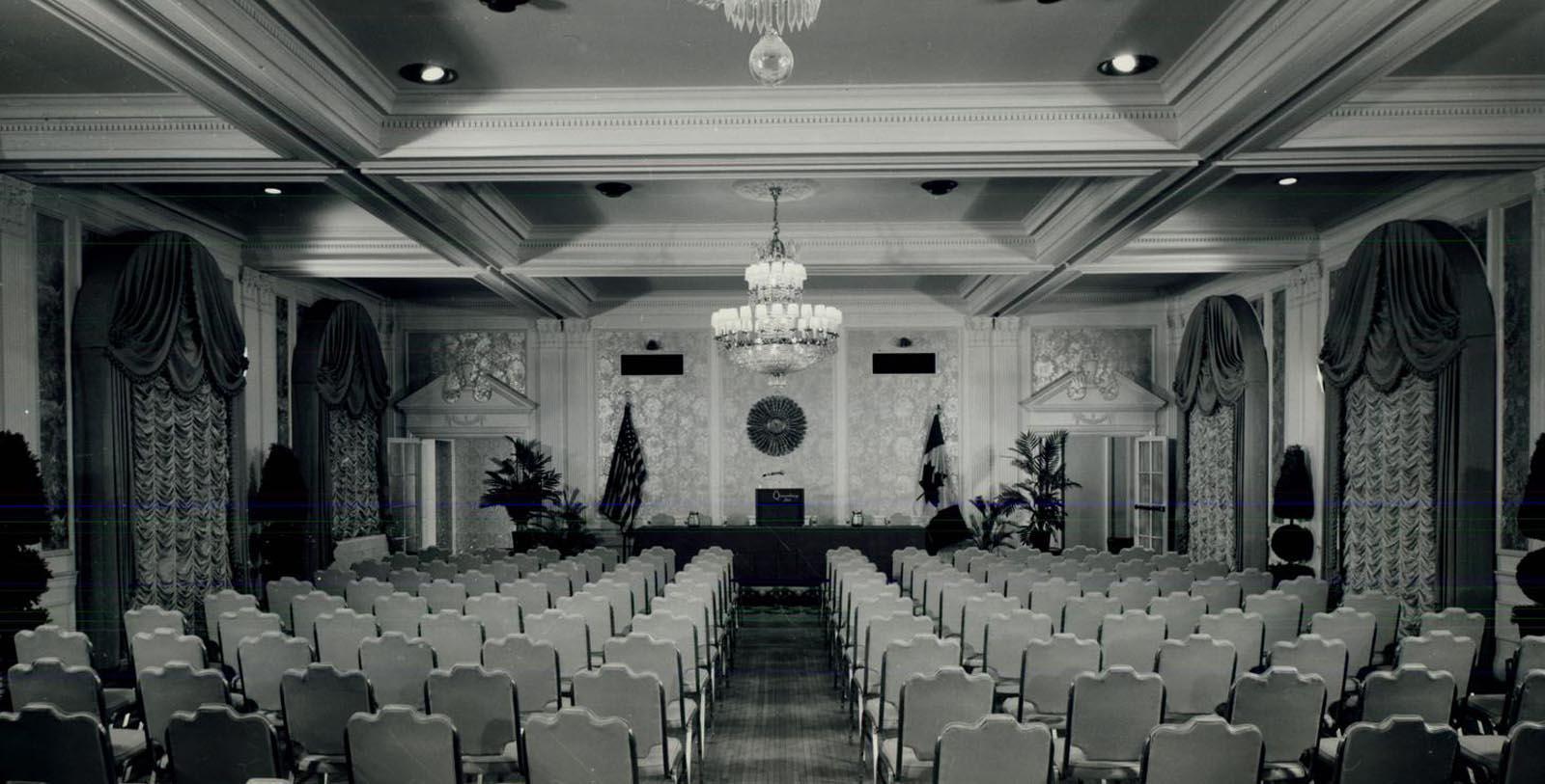 a room with chairs and chandelier