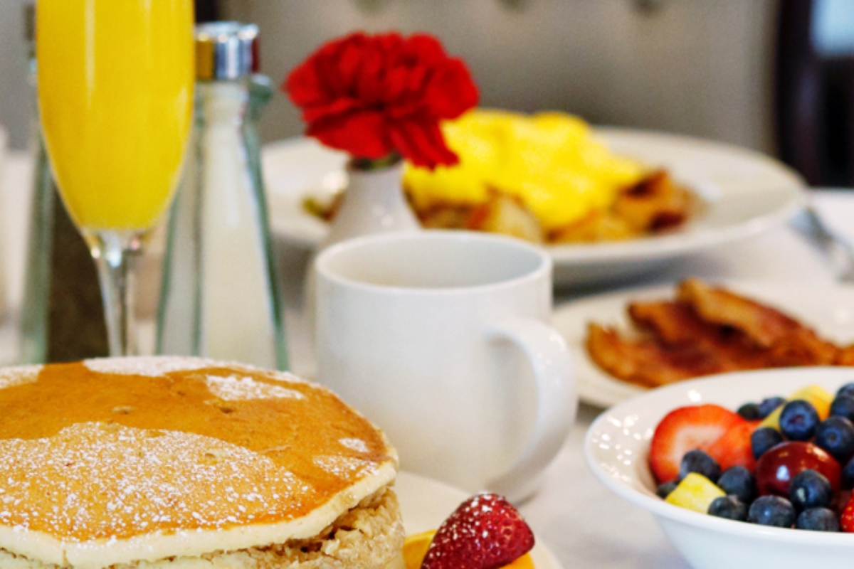 a breakfast table with food and drinks