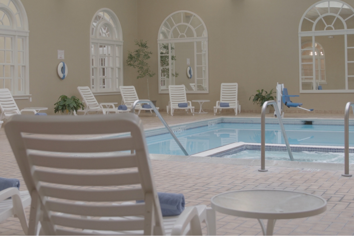 a pool with chairs and a table