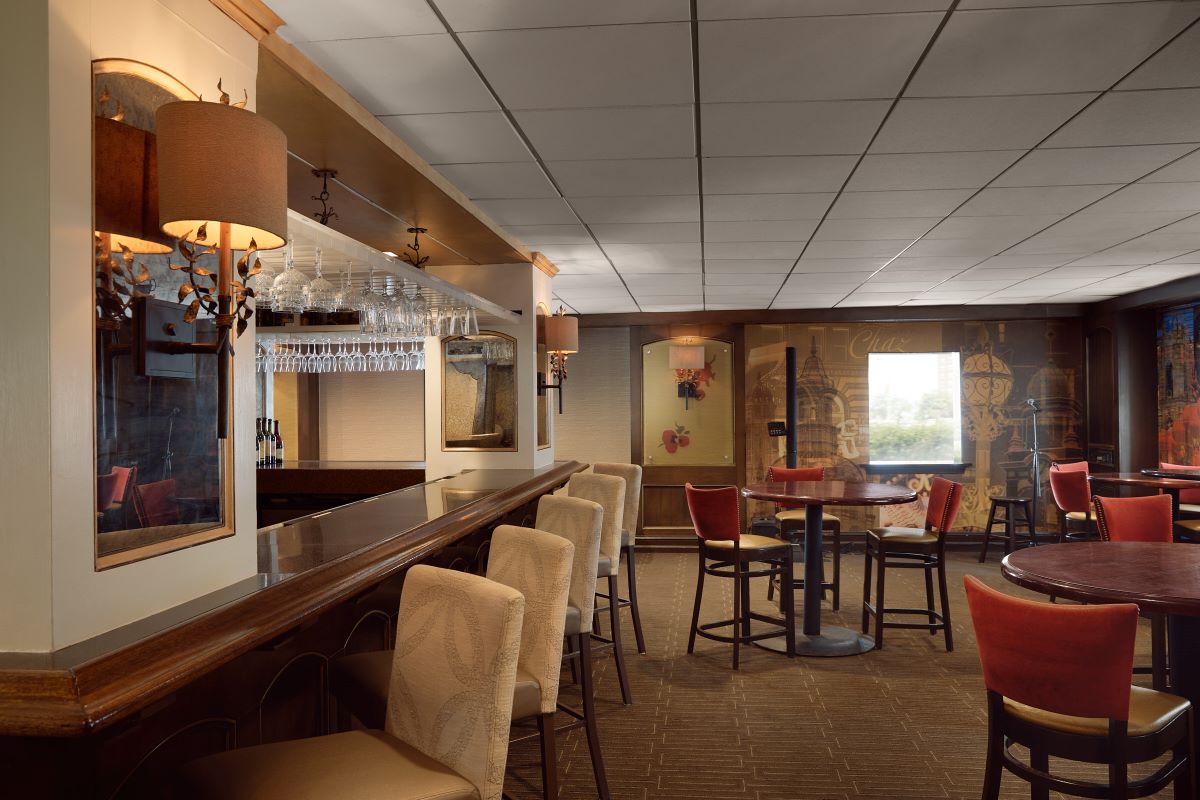a room with a bar and chairs