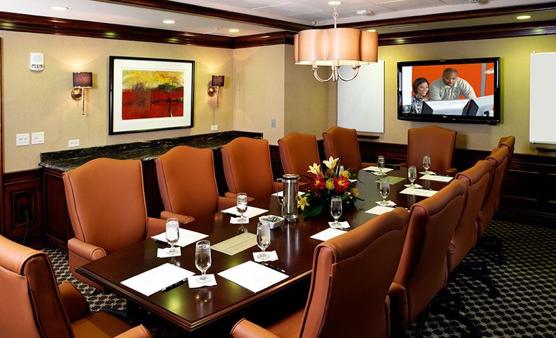 a conference room with a table and chairs