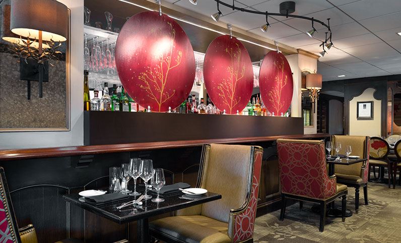 a restaurant with a bar and chairs