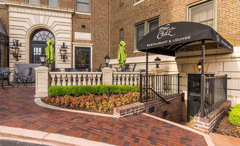 a restaurant and lounge building with a brick walkway
