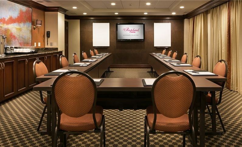 a room with a long table and chairs