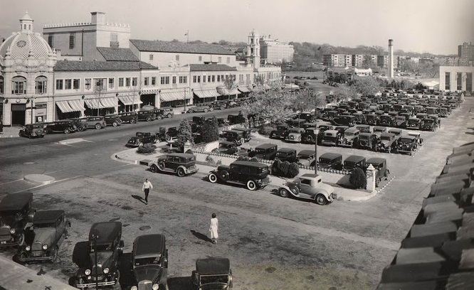 a parking lot with cars and buildings
