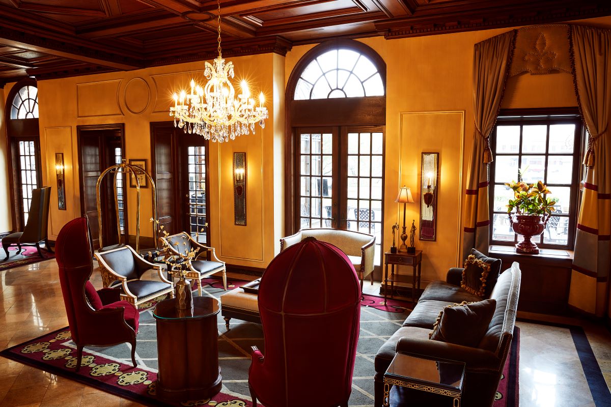 a room with a chandelier and couches
