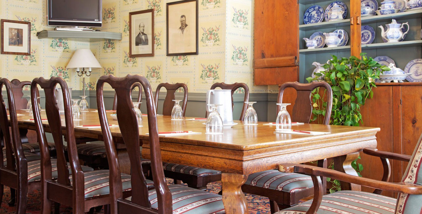 a dining table with chairs and glasses