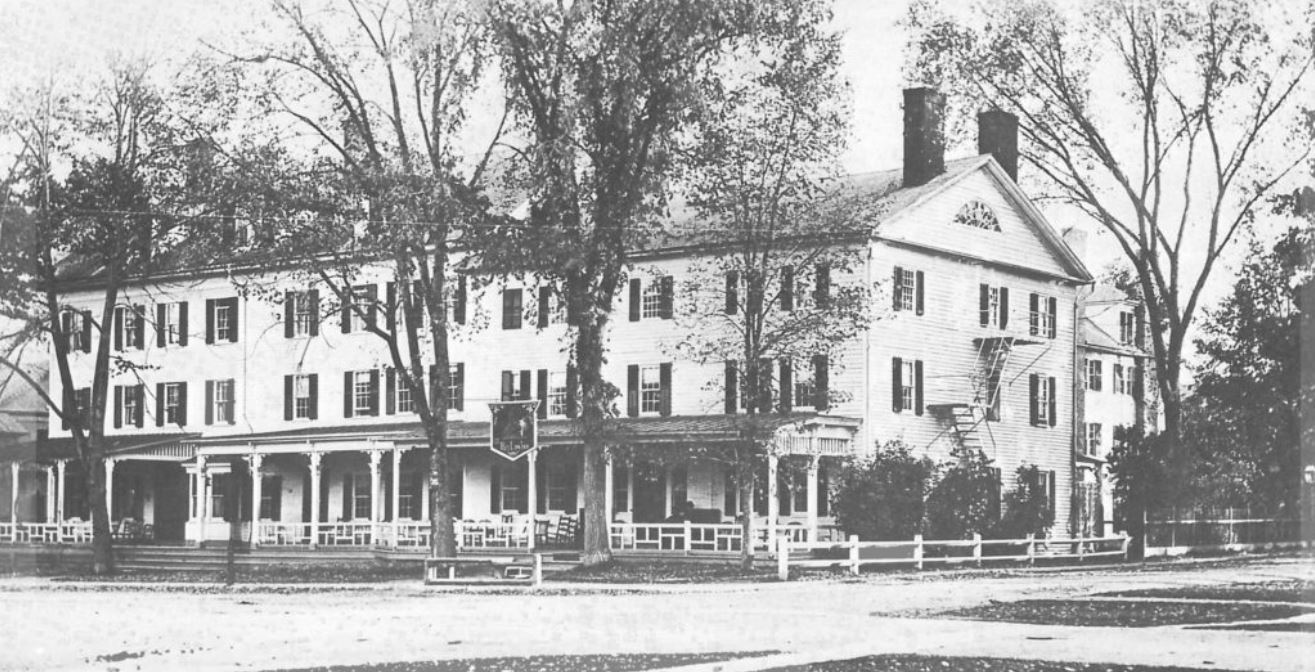 a large white building with trees
