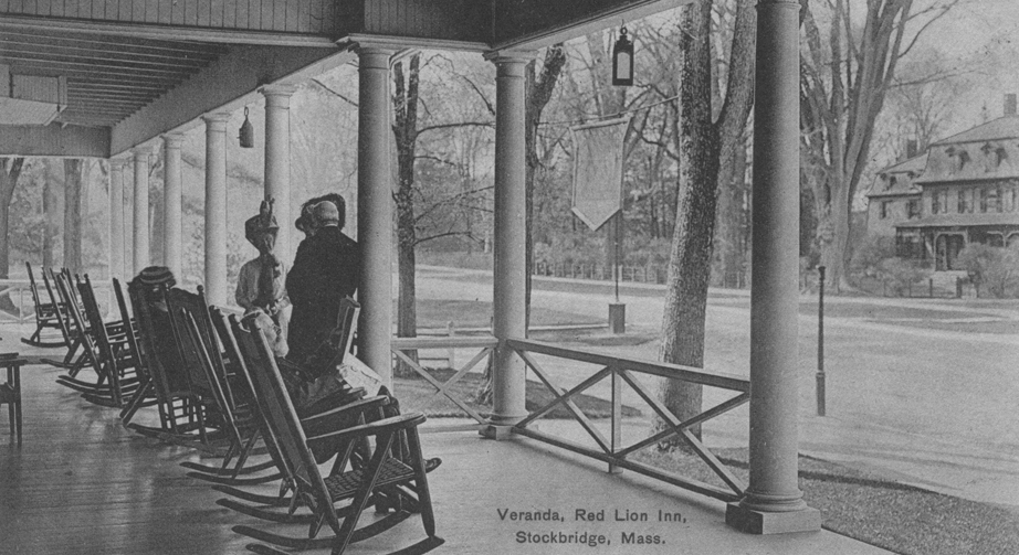 a group of people sitting on a porch