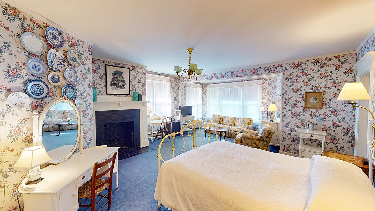 a bedroom with a fireplace and a bed