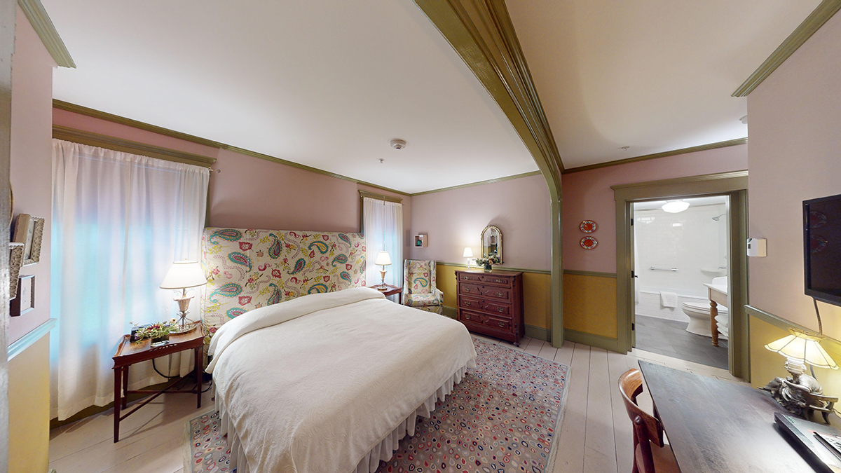 a bedroom with a bed and a table