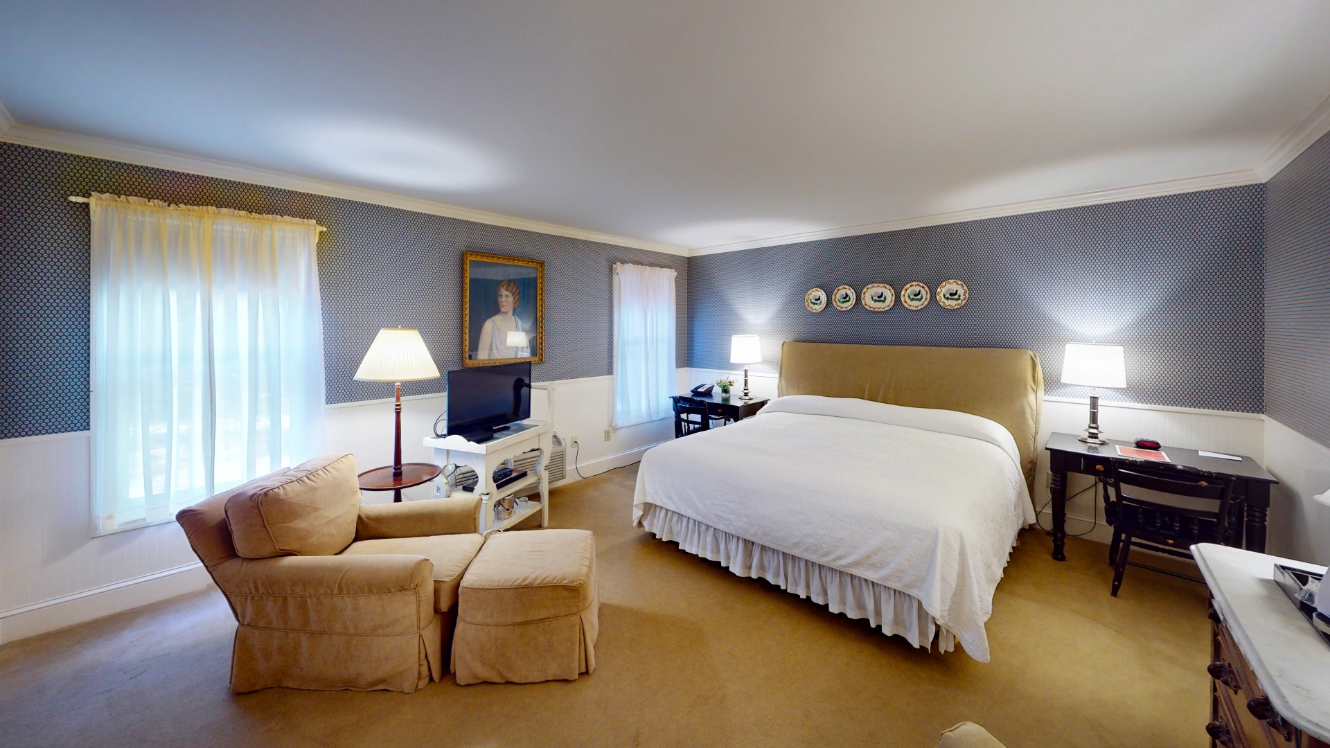a bedroom with a bed and a television