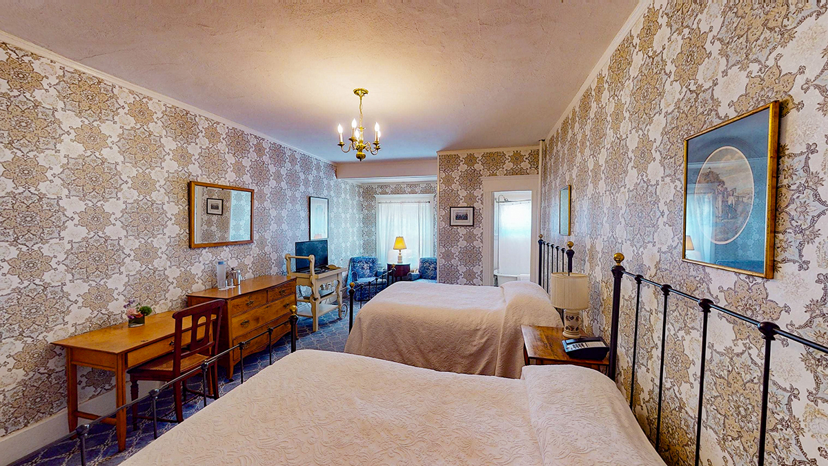 a room with two beds and a television