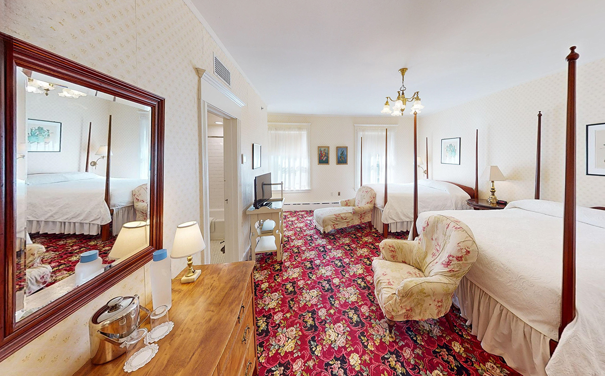 a room with two beds and a mirror
