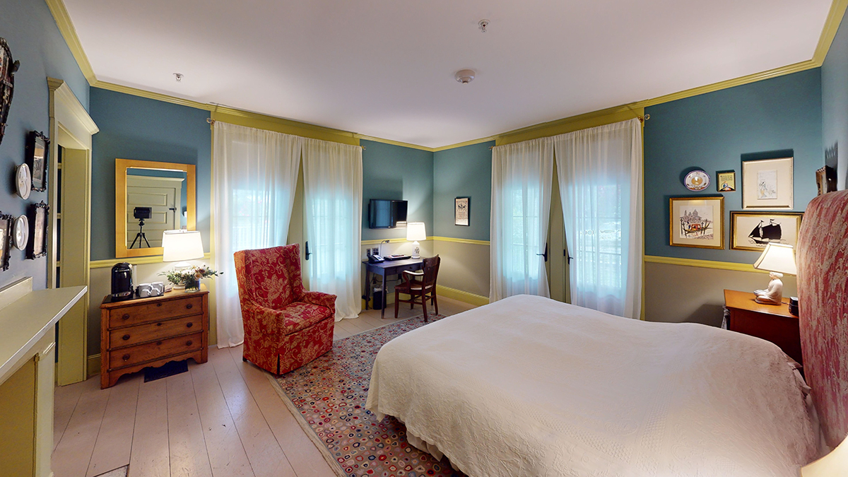 a bedroom with a bed and a chair