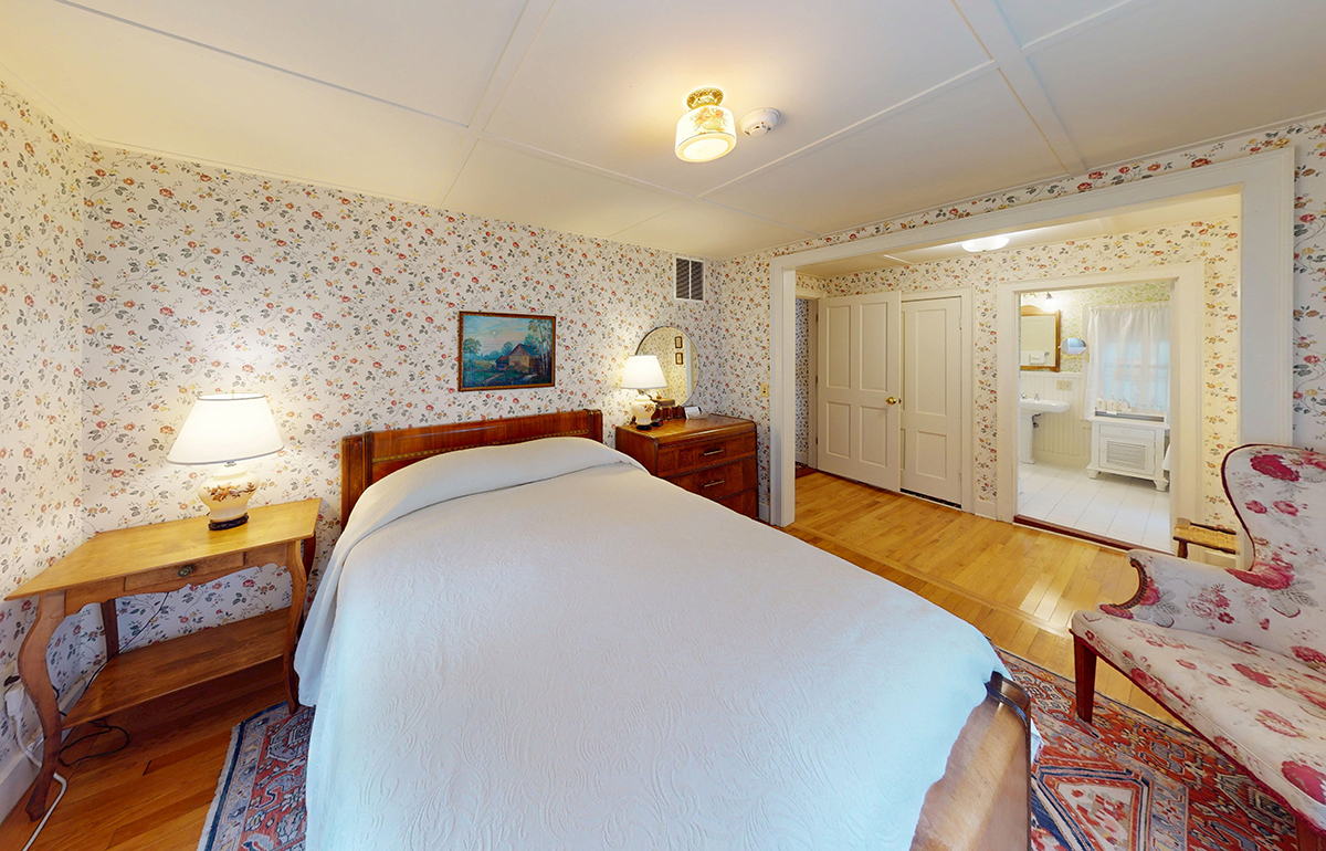 a bedroom with a bed and a dresser