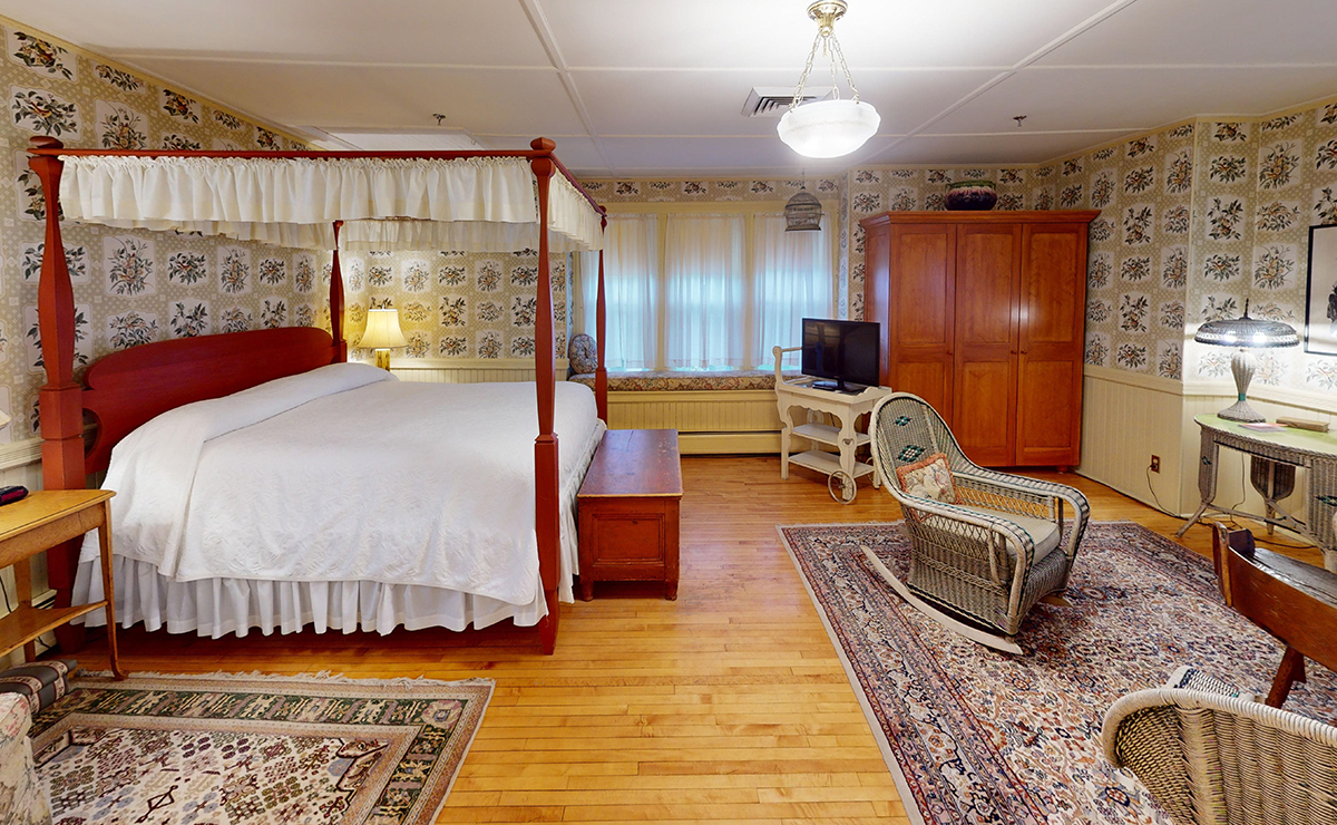 a bedroom with a bed and a television