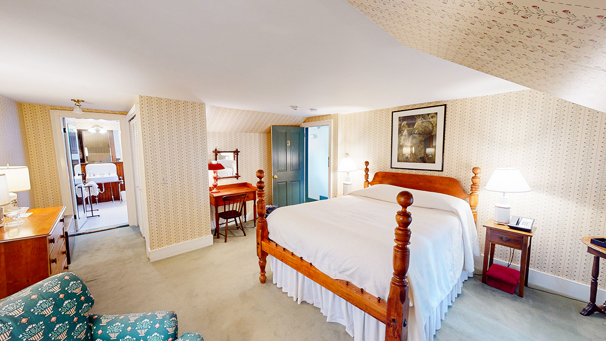 a bedroom with a bed and a desk
