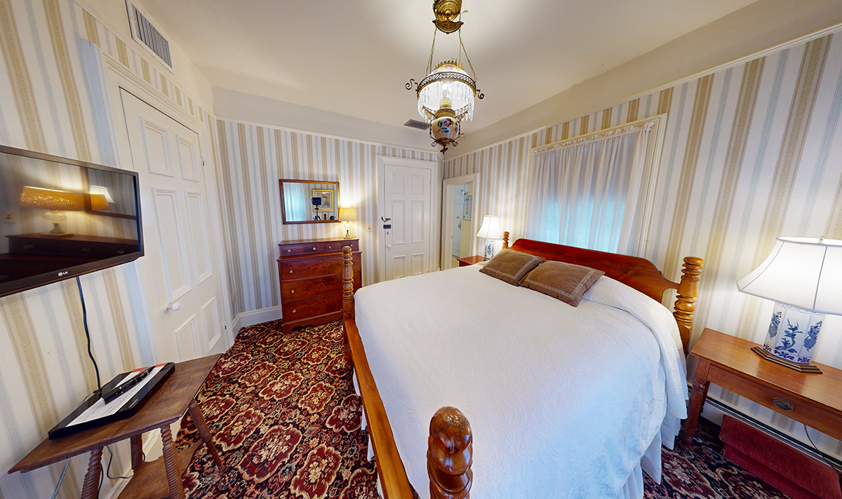a bedroom with a bed and a dresser