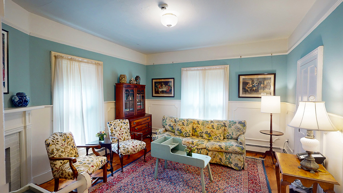 a living room with a couch and chairs