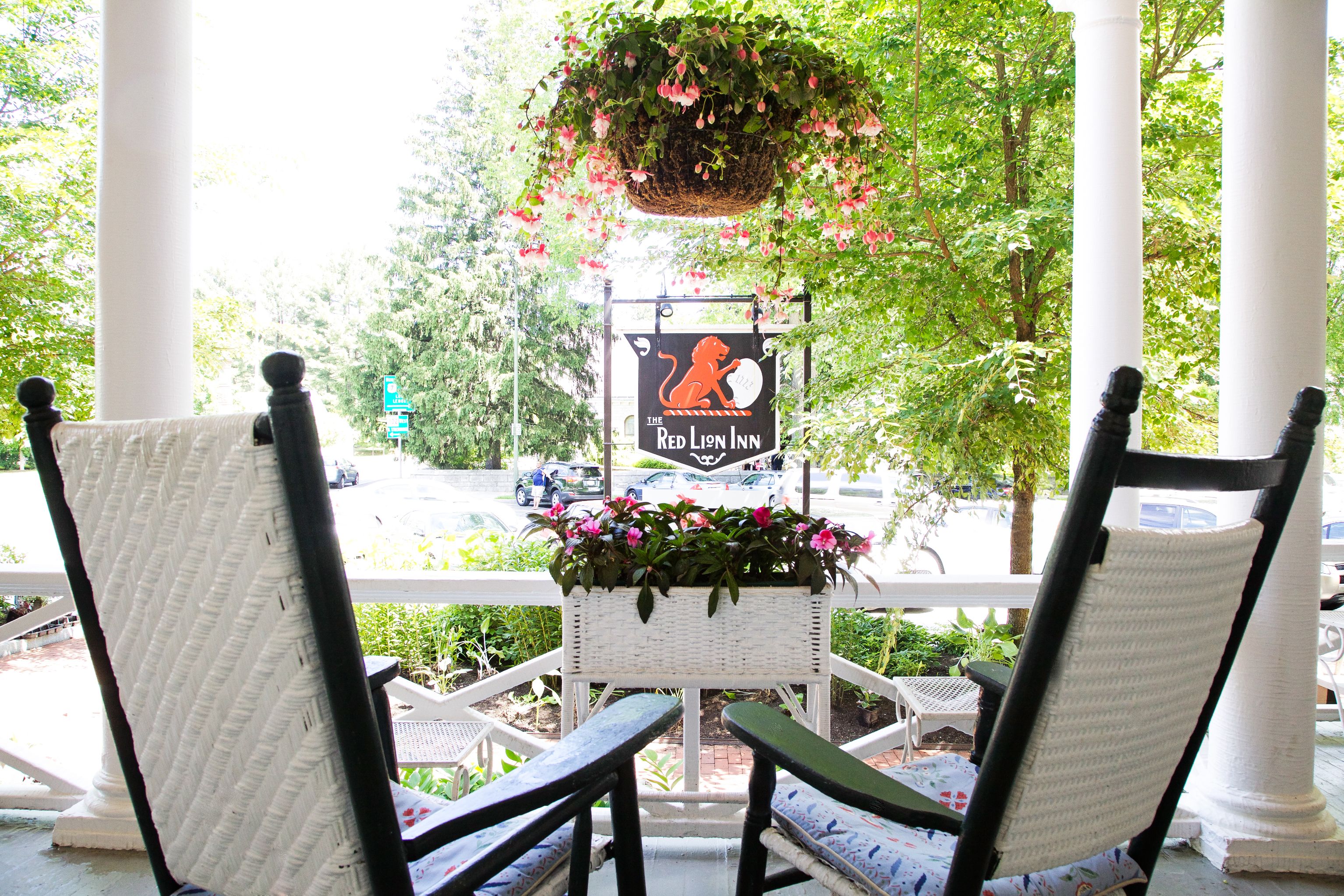 chairs on a porch with chairs and a sign