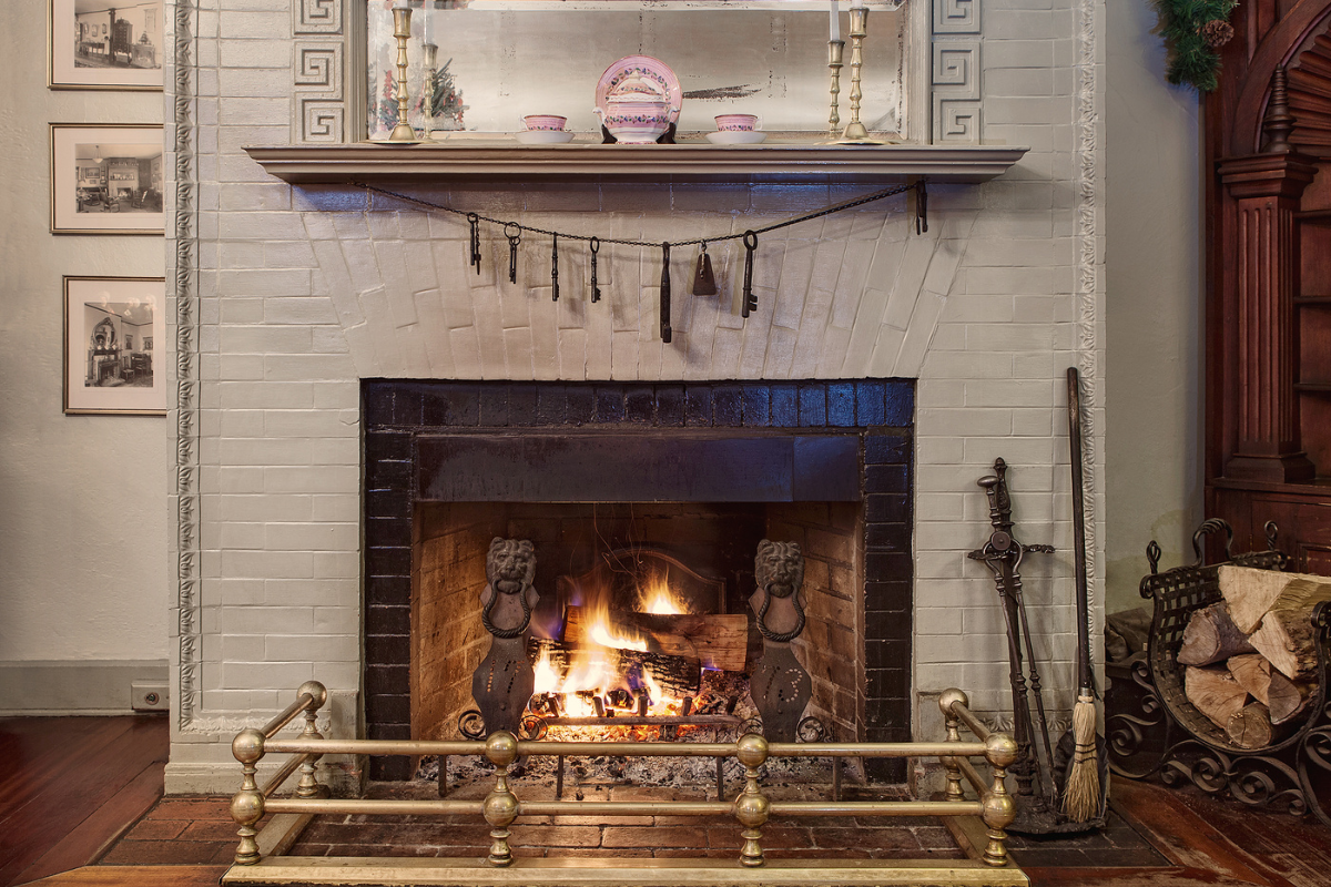 a fireplace with a fire and a shelf