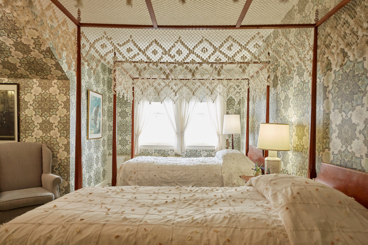 a room with two beds and a window