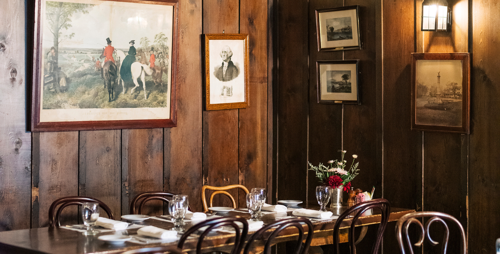 a table set up in a room with a picture on the wall